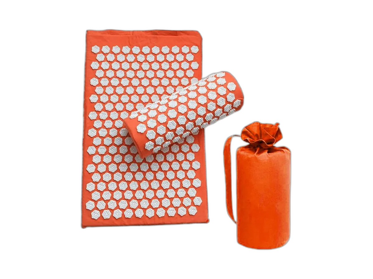 Orange LotusMat pressure-point mat, matching pillow, and rolled carrier on a transparent background