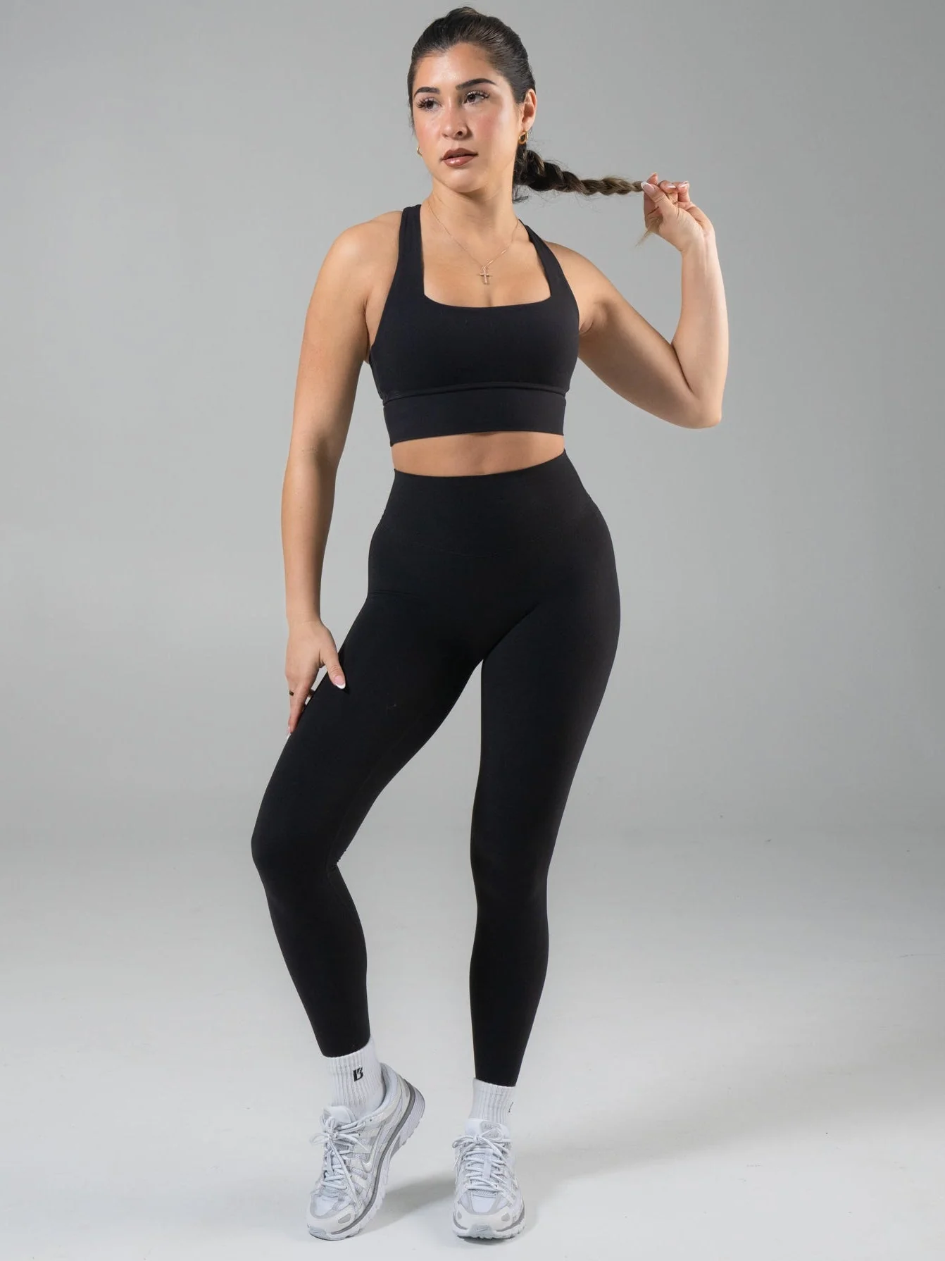 Model wearing Buffbunny black Micro Legacy leggings in official product photography.